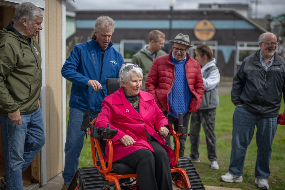 Attendees try out the Track Chair at the Agate Beach Grand Opening