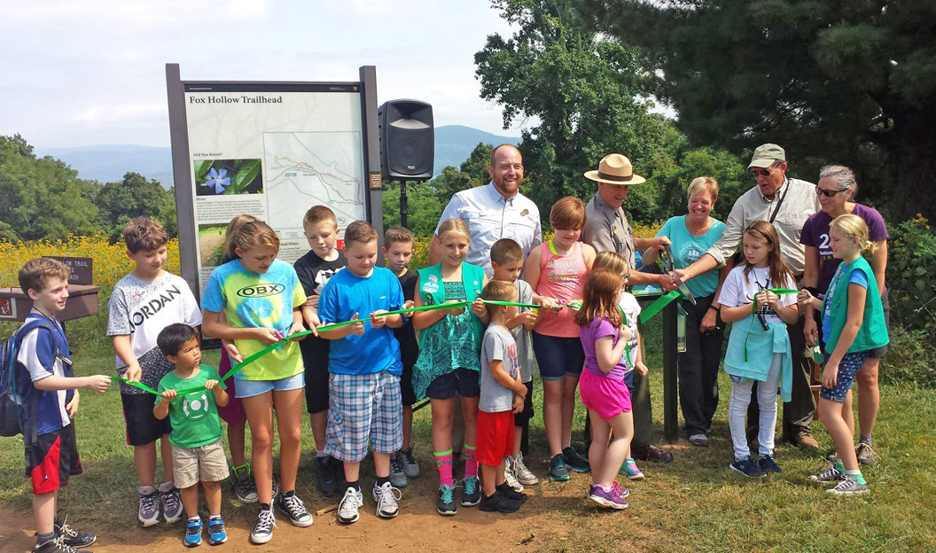 kids at a ribbon cutting ceremony