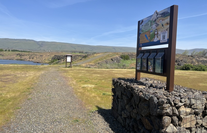 view of trailhead kiosk and gravel trail