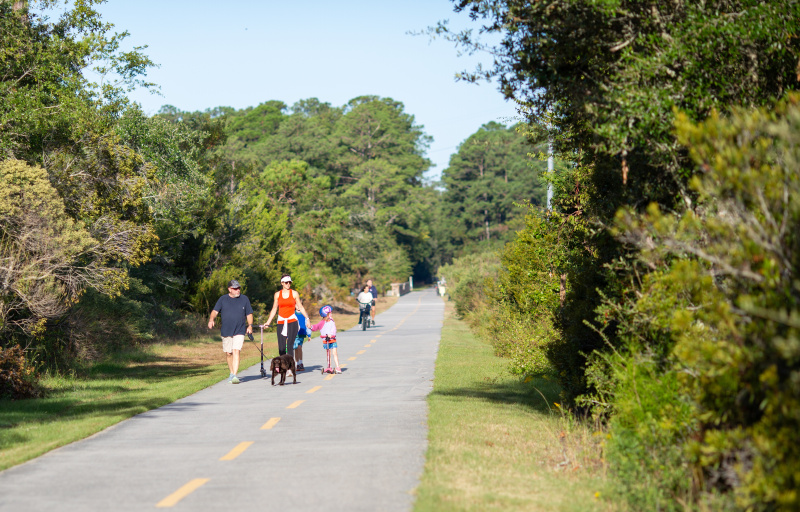 Family with dog walking along the trail
