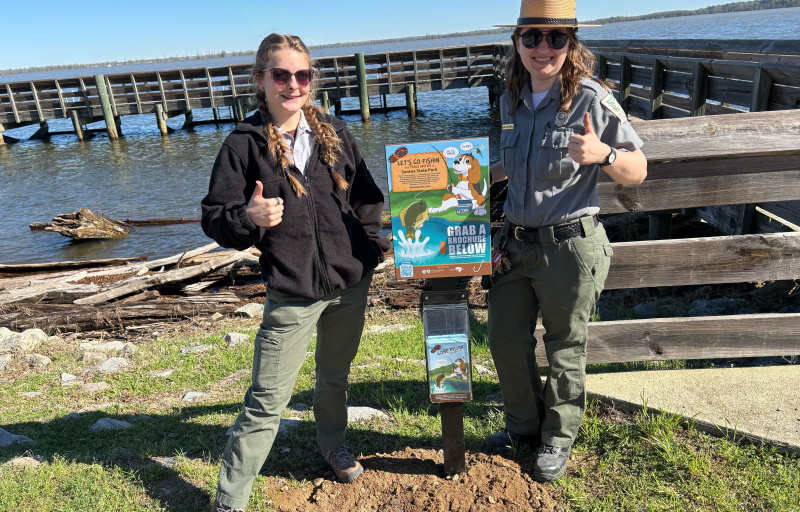 Rangers with fishing sign