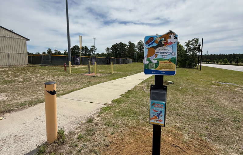 Photo of the track trail mini sign along the sidewalk at north central