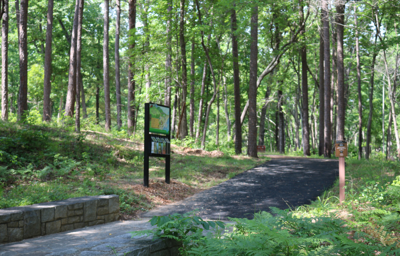 The Kings Mountain National Military Kiosk stands next to a forested trail.