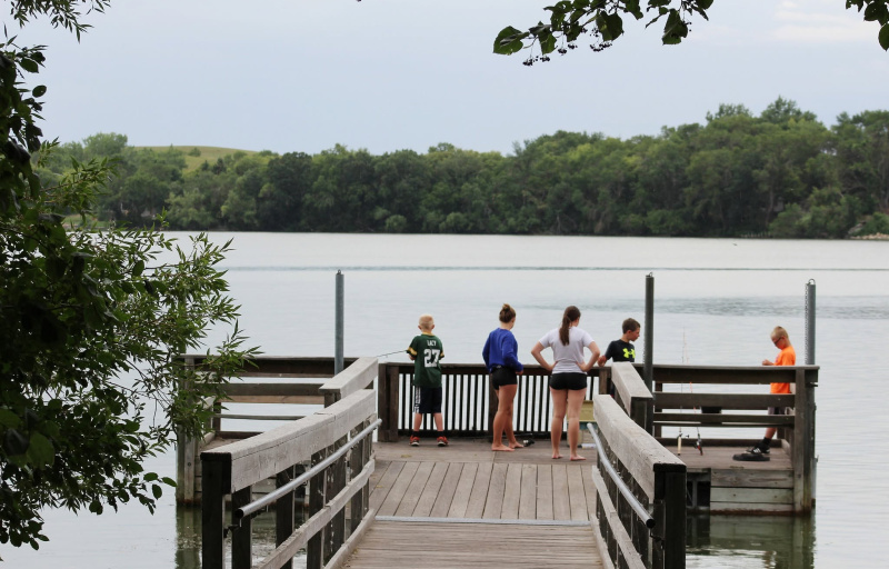 A view of the dock with people fishing and observing on it