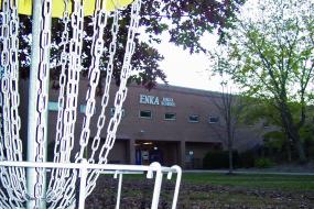 close up of a hole with enka high school in the background