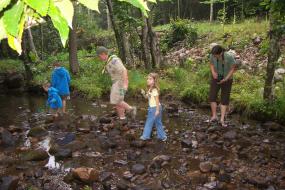 Kids exploring a stone filled creek