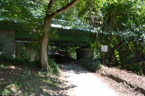 Paved path passing under a bridge