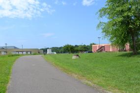 Paved trail running behind businesses