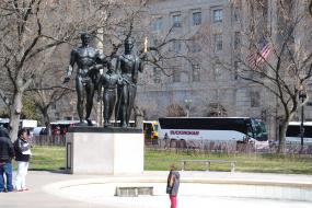 Young boy standing in front of Boy Scout Memorial 