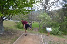 boy throwing a disc on hole 8