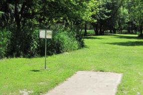 disc golf sign and the starting point for one of the holes on the course