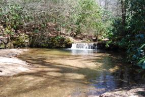 Small waterfall flowing into a shallow pool