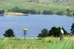 Hole on the course with the reservoir in the background