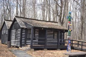 Log cabin with totem pole in front