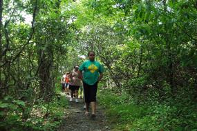 Kids hiking on wooded section of trail