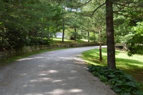 Gravel roadway bordered by a stacked stone wall