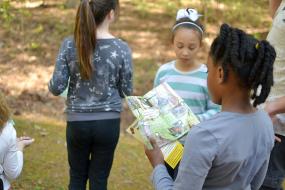 Kid using the Hide and Seek brochure