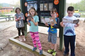 Kids read through brochures at the trailhead