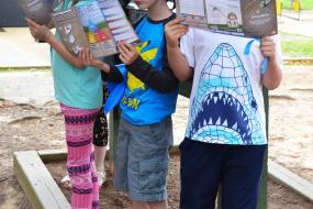 Kids reading citizen science brochures
