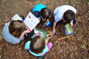 Overhead shot of kids reading through tool instructions