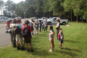 Group of kids gathered around a ranger