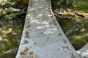 A stone bridge takes you over the creek in this section