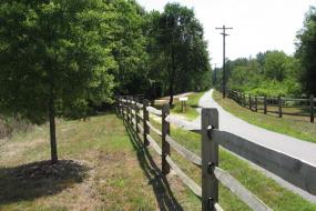 Split rail fence by paved trail