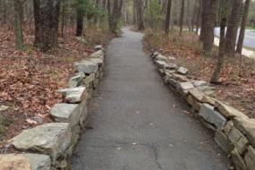 Paved path lined with rock wall