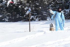 Disc golfer throwing a shot in the snow