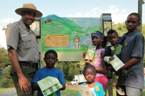 Kids and Ranger in front of TRACK Trail sign